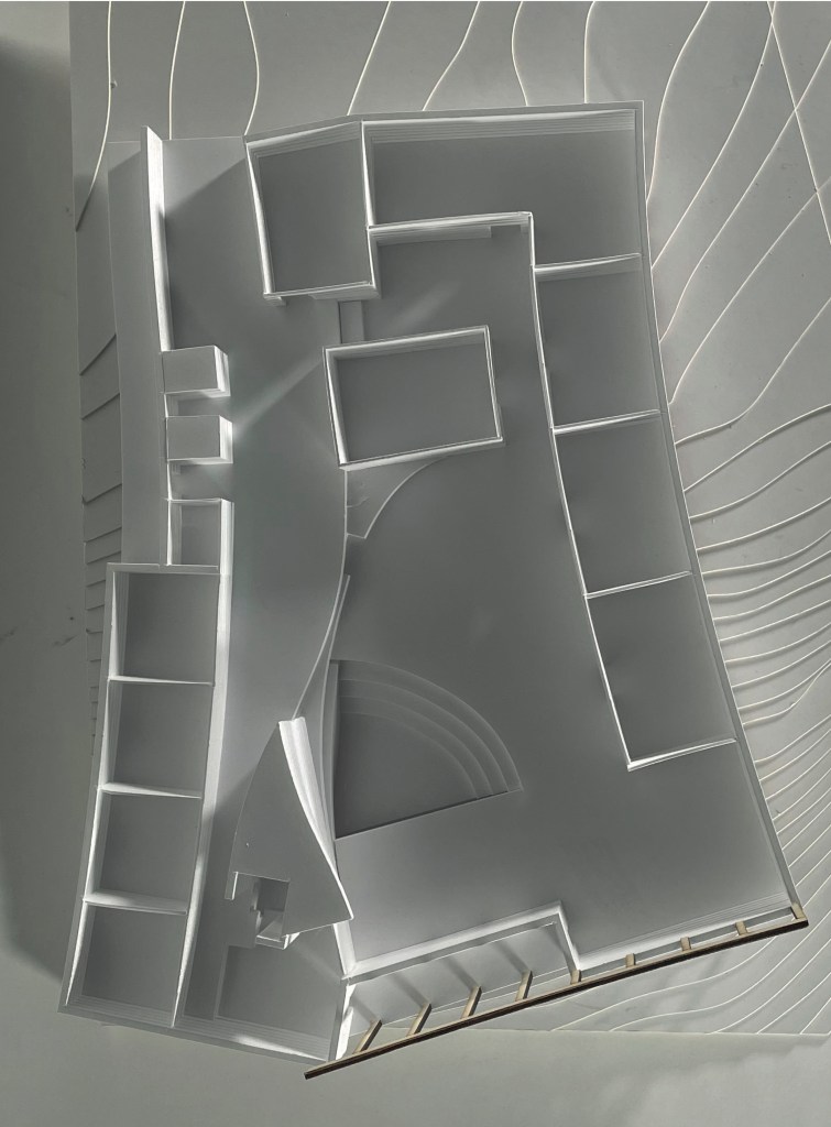 white architecural model seen from above with slightly bent shapes